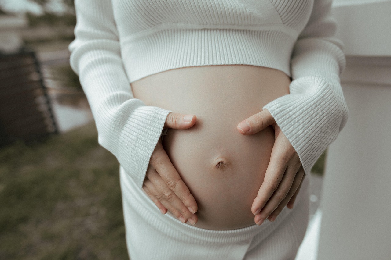 Pregnant woman cradling her belly